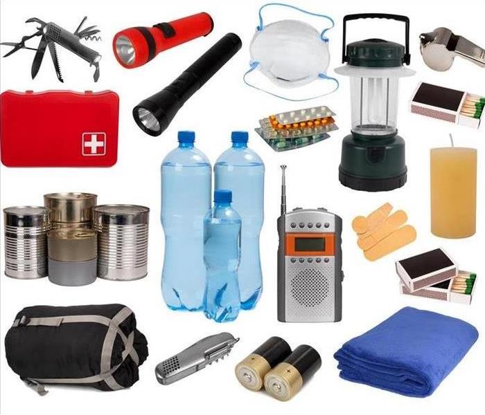 Flash light, sleeping bag, bottled water, first aid, portable radio, matches, medicine, band aids, whistle, blanket. 